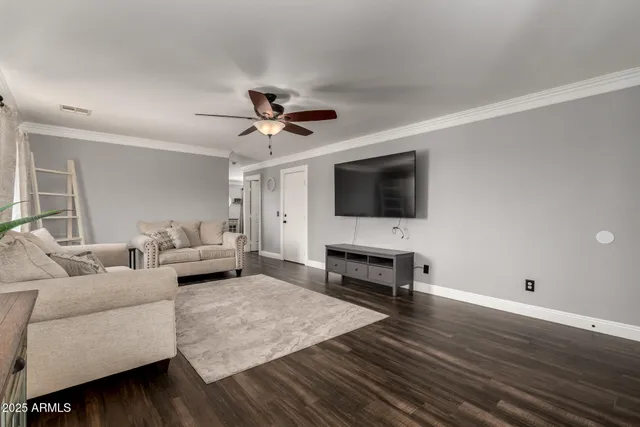 a living room with furniture and a flat screen tv