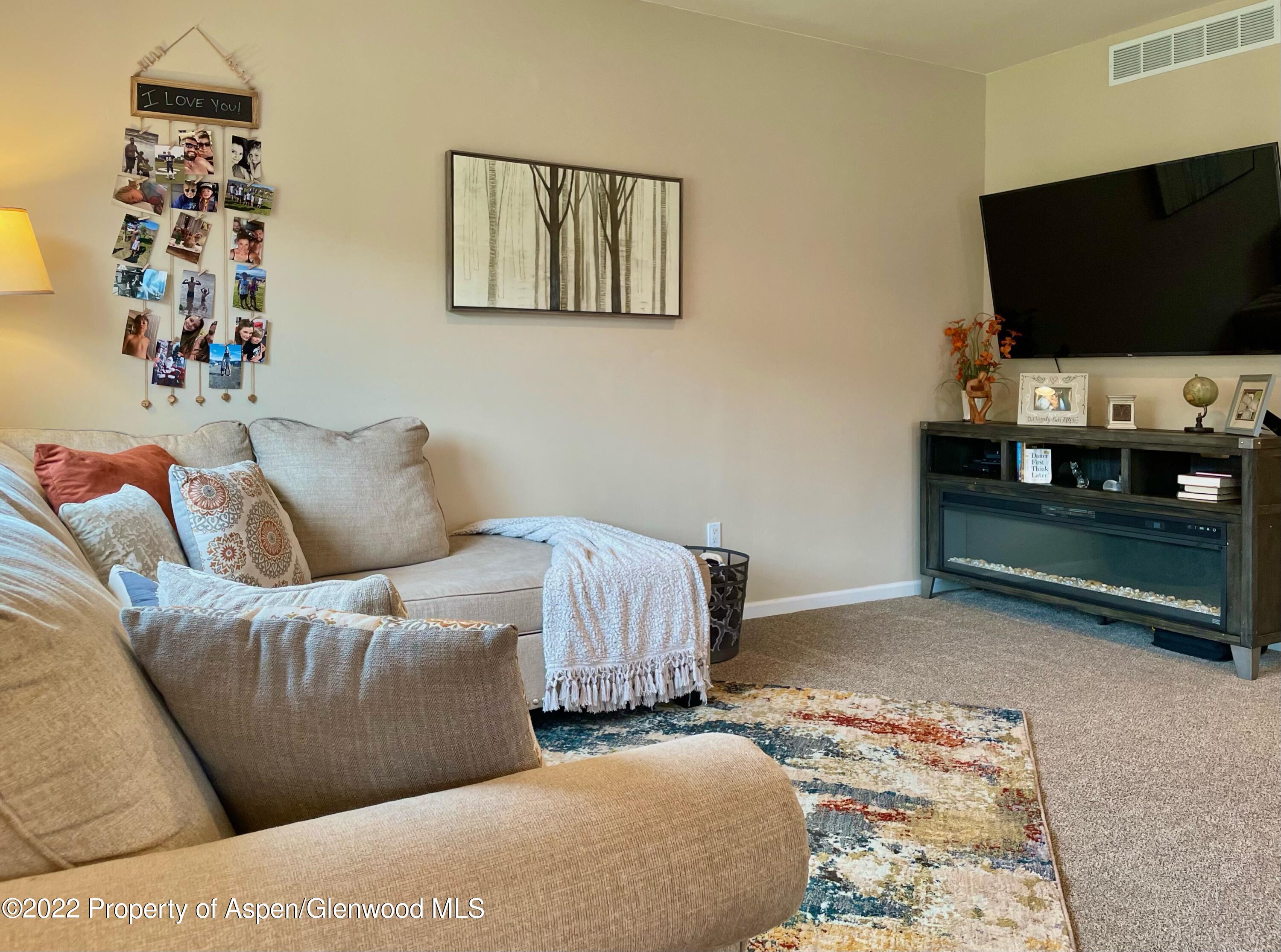 133 Castle Ridge Drive New Castle, CO 81647 - Photo 15 of 32 a living room with furniture and a flat screen tv