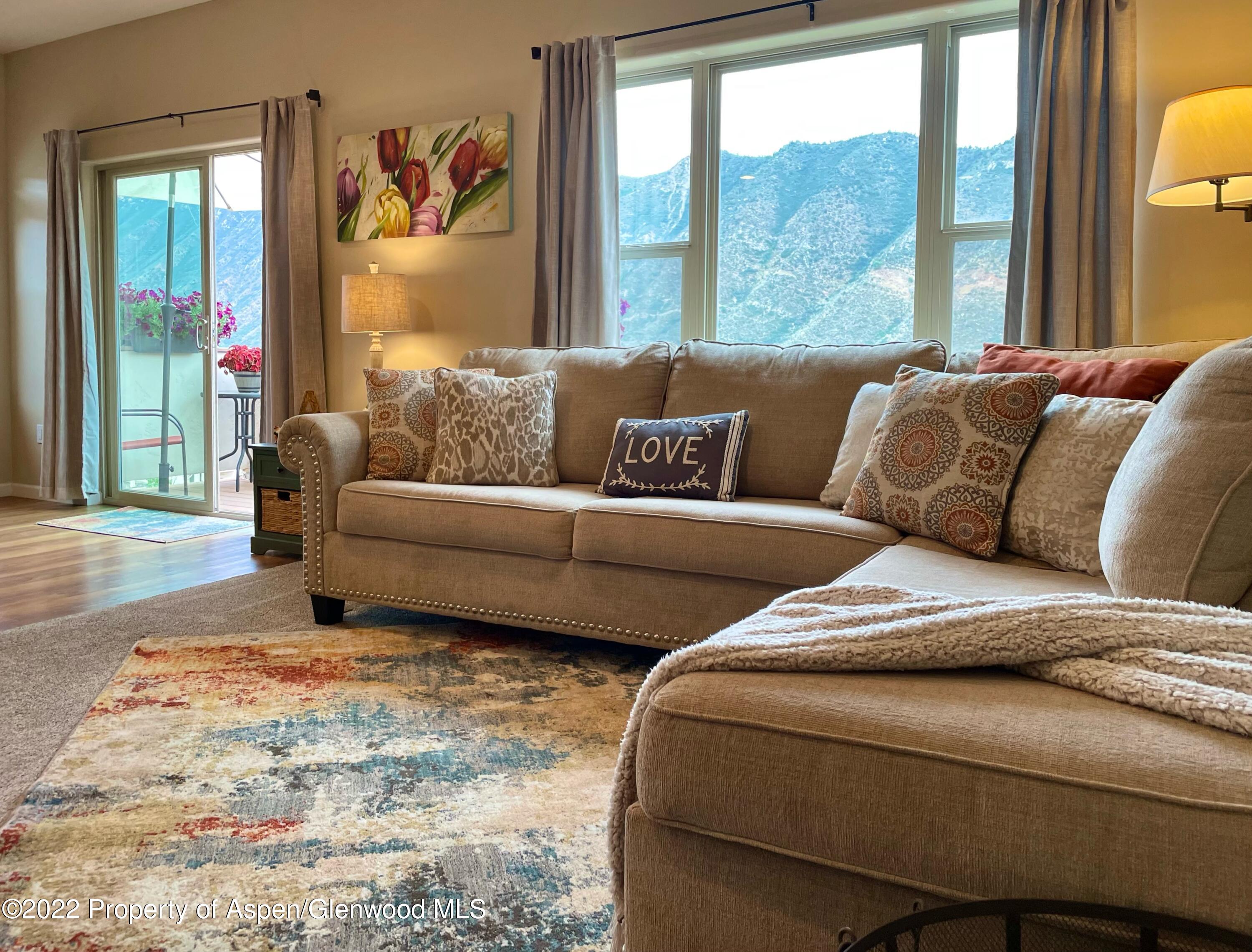 133 Castle Ridge Drive New Castle, CO 81647 - Photo 16 of 32 a living room with couches and a large window with garden view