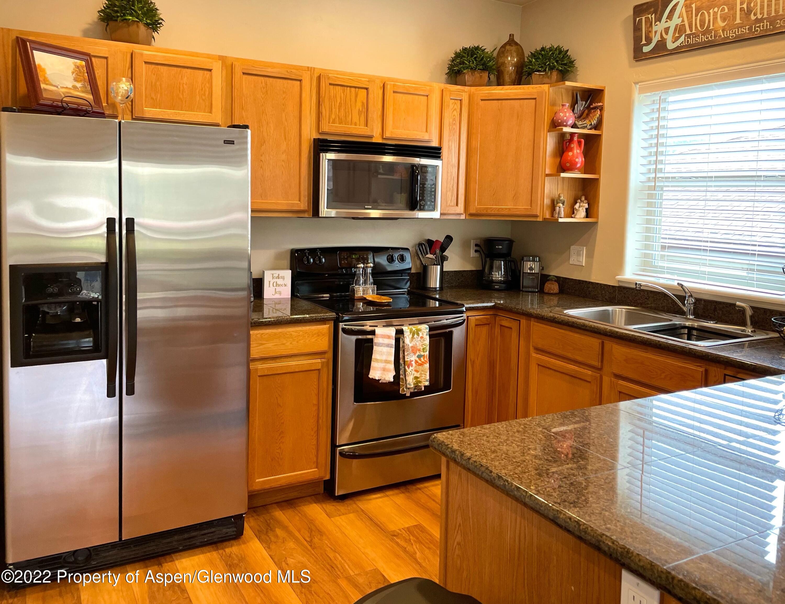 133 Castle Ridge Drive New Castle, CO 81647 - Photo 18 of 32 a kitchen with stainless steel appliances granite countertop a sink a stove and a refrigerator