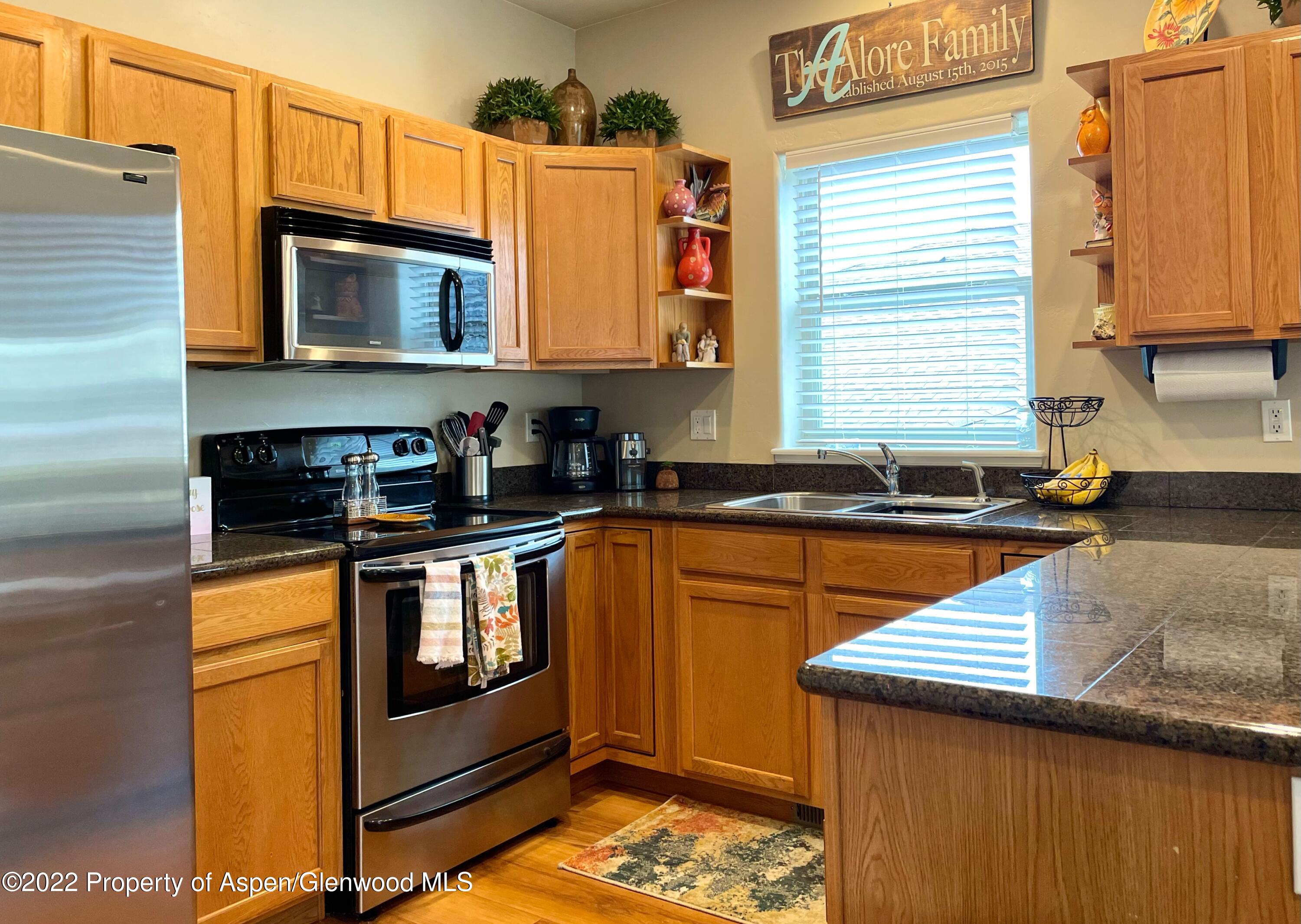 133 Castle Ridge Drive New Castle, CO 81647 - Photo 19 of 32 a kitchen with stainless steel appliances granite countertop a stove a sink and a microwave