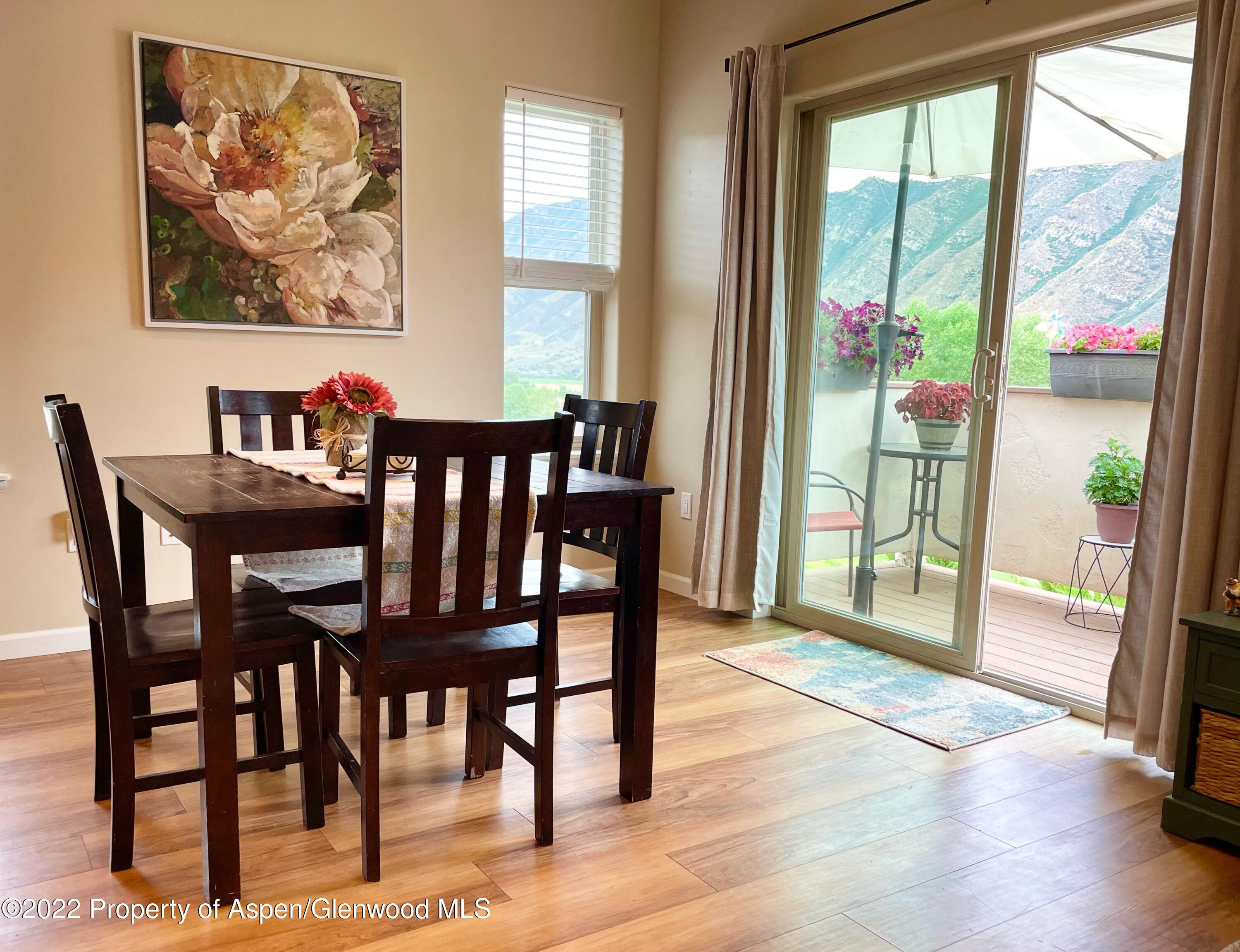 133 Castle Ridge Drive New Castle, CO 81647 - Photo 23 of 32 a view of a dining room with furniture wooden floor and a potted plant