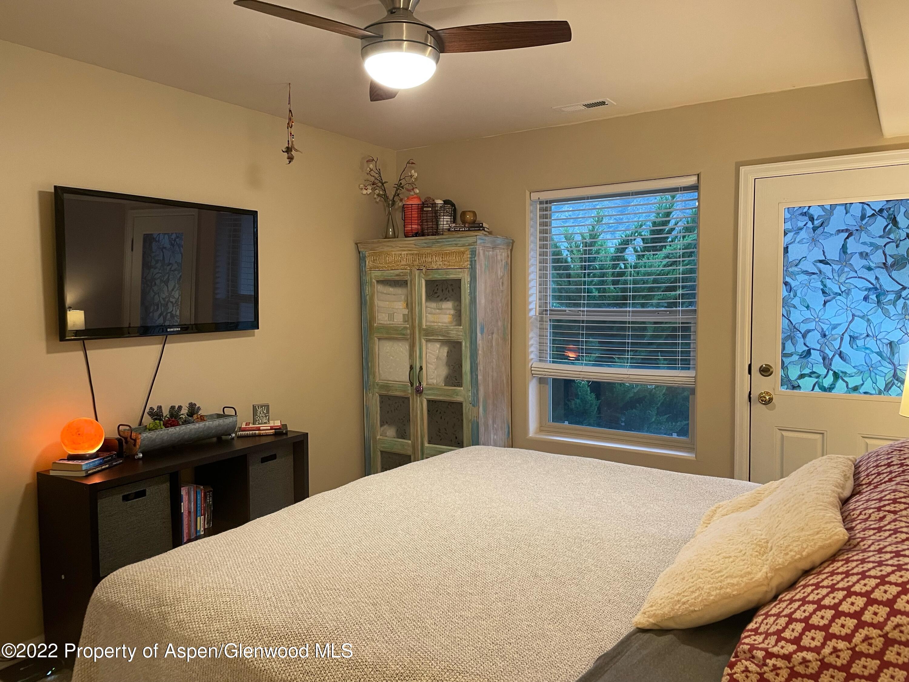 133 Castle Ridge Drive New Castle, CO 81647 - Photo 27 of 32 a bedroom with a bed and a flat screen tv