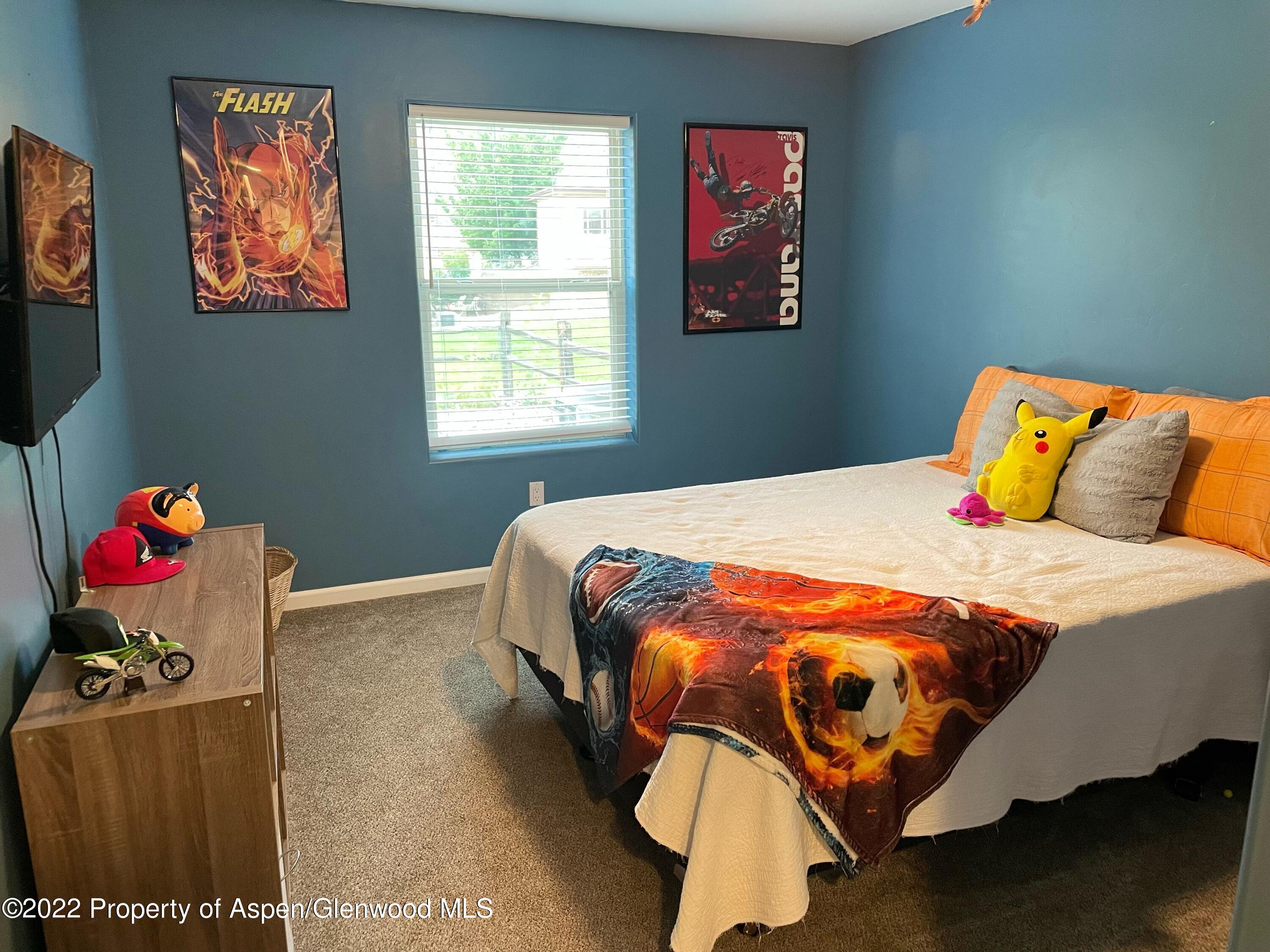 133 Castle Ridge Drive New Castle, CO 81647 - Photo 30 of 32 a bedroom with a bed and painting on the wall