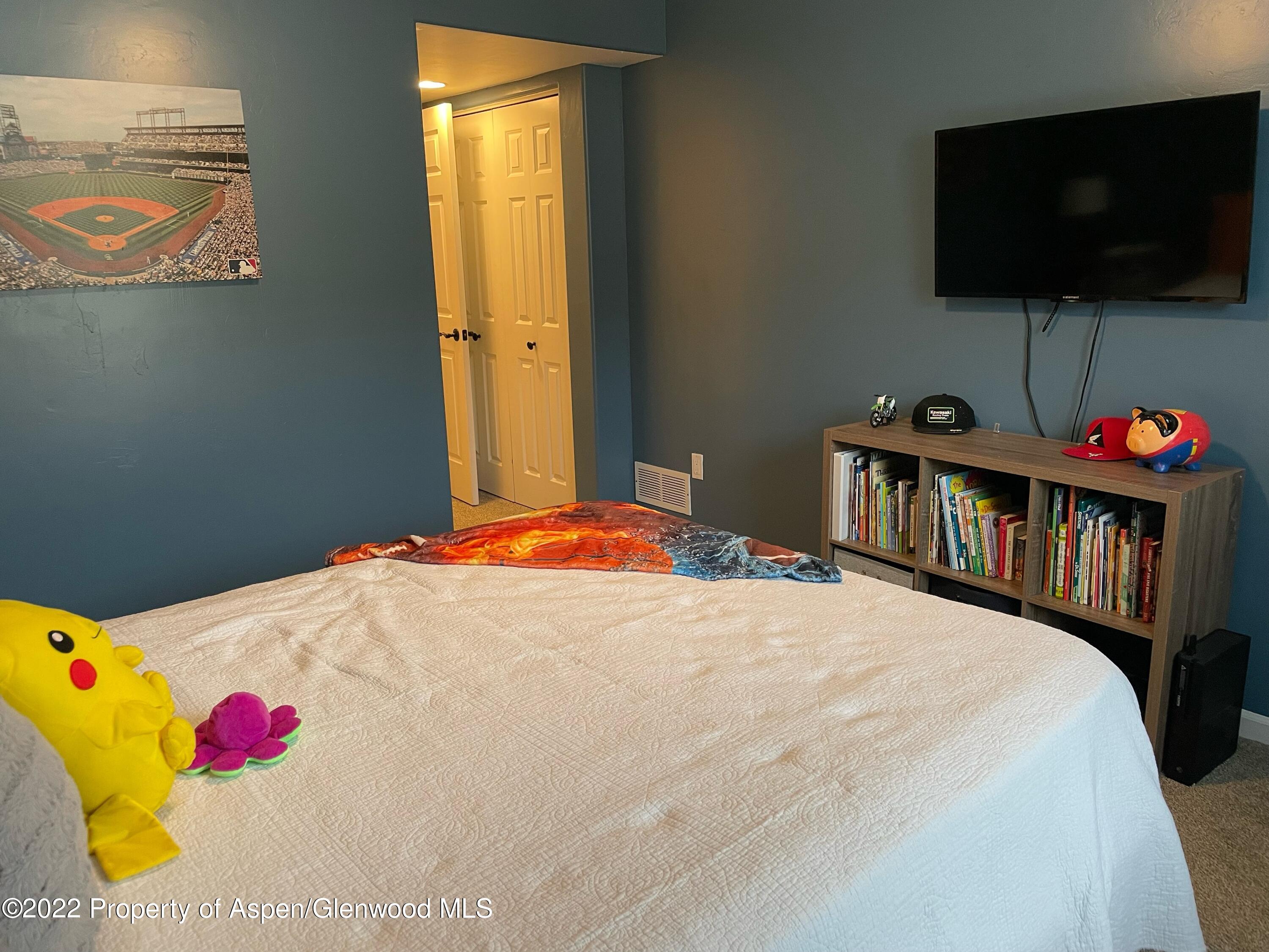 133 Castle Ridge Drive New Castle, CO 81647 - Photo 31 of 32 a bedroom with a bed and flat screen tv