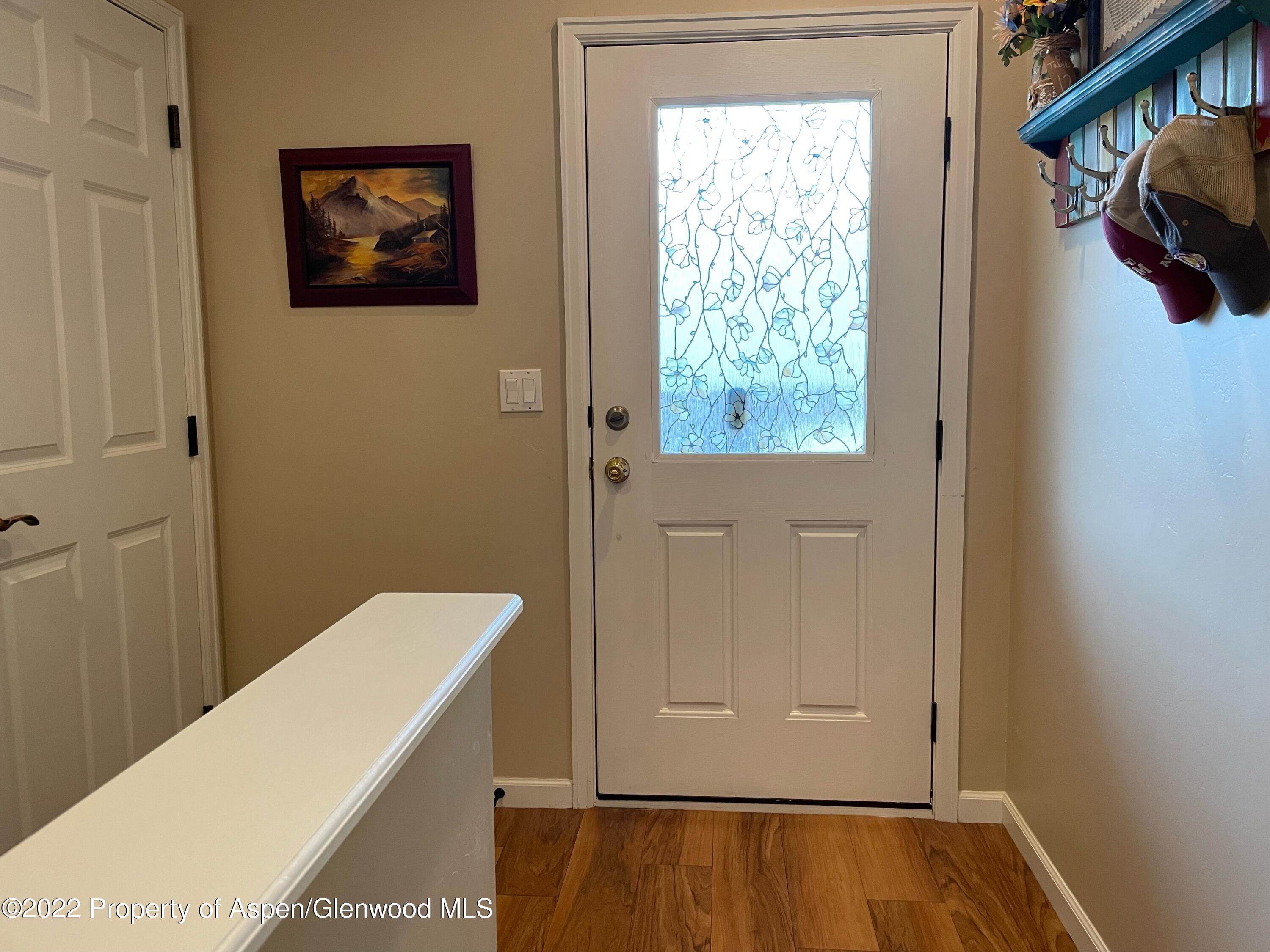 133 Castle Ridge Drive New Castle, CO 81647 - Photo 9 of 32 a view of a hallway with wooden floor and a large window