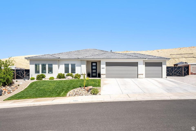 5963 Flattop Drive St. George, UT 84790 - Photo 1 of 45 Contemporary single-story residence featuring a light-colored stucco and siding exterior, a multi-car concrete driveway, and a low-pitched shingled roof