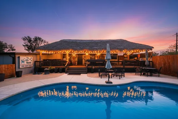 a view of a swimming pool with a table & chairs