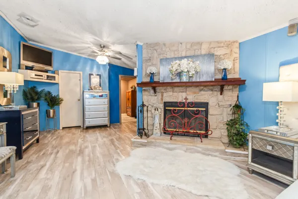 a living room with furniture a fireplace and a flat screen tv