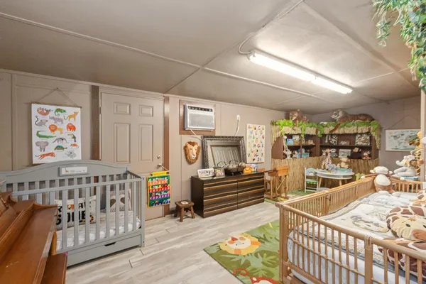 a bedroom with furniture and wooden floor