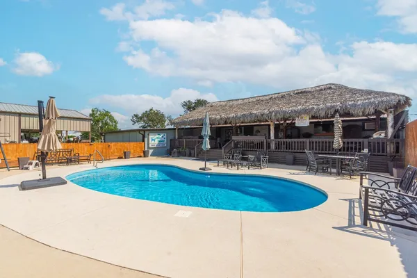 a view of a house with swimming pool and sitting area