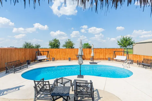 an outdoor space with patio and seating space