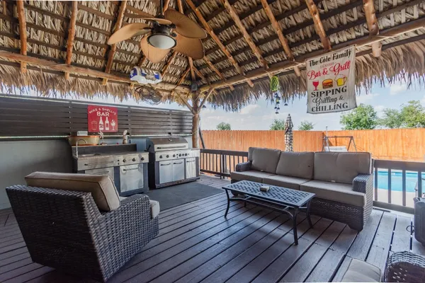 a outdoor living space with patio furniture and wooden floor