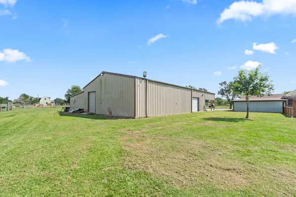 a backyard of a house with plants and a yard