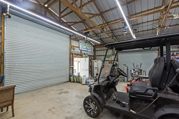 an aerial view of a house with a garden and lake view