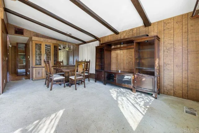a view of a porch with chairs and floor to ceiling window