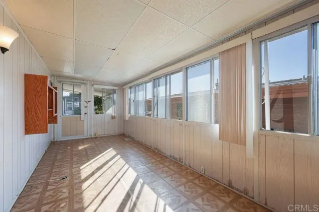 a view of an entryway with wooden floor and windows