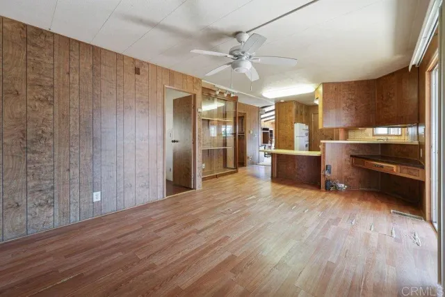 a view of kitchen with wooden floor and electronic appliances