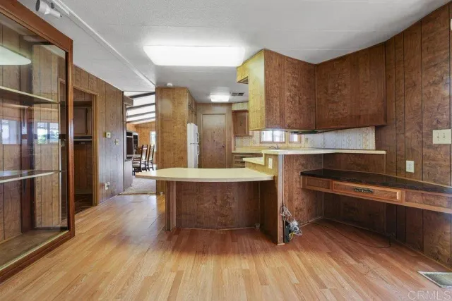 a kitchen with granite countertop a sink and cabinets