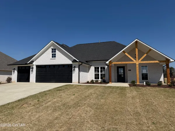 a front view of a house with yard