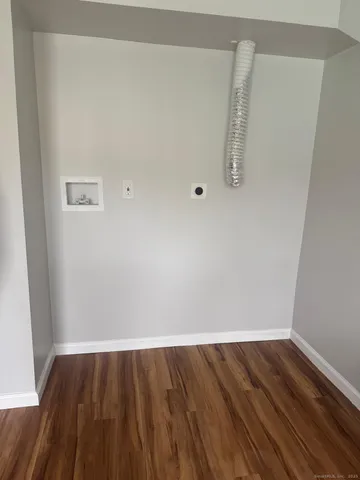 a view of a room with wooden floor