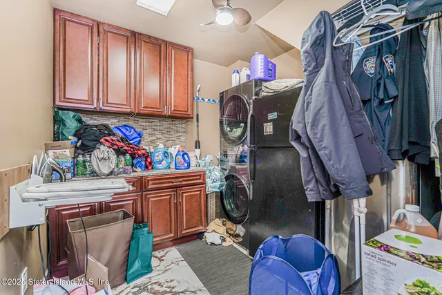 a view of walk in closet with clothes