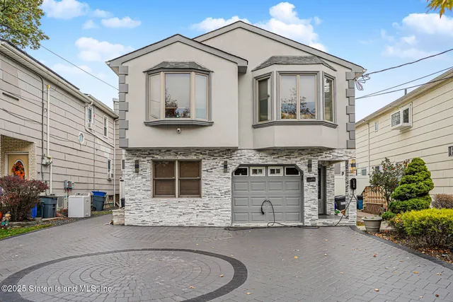 a front view of a house with a garage