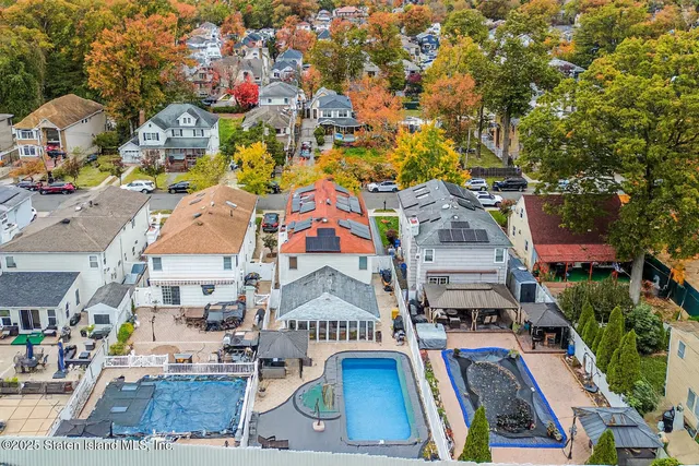 an aerial view of multiple houses with yard