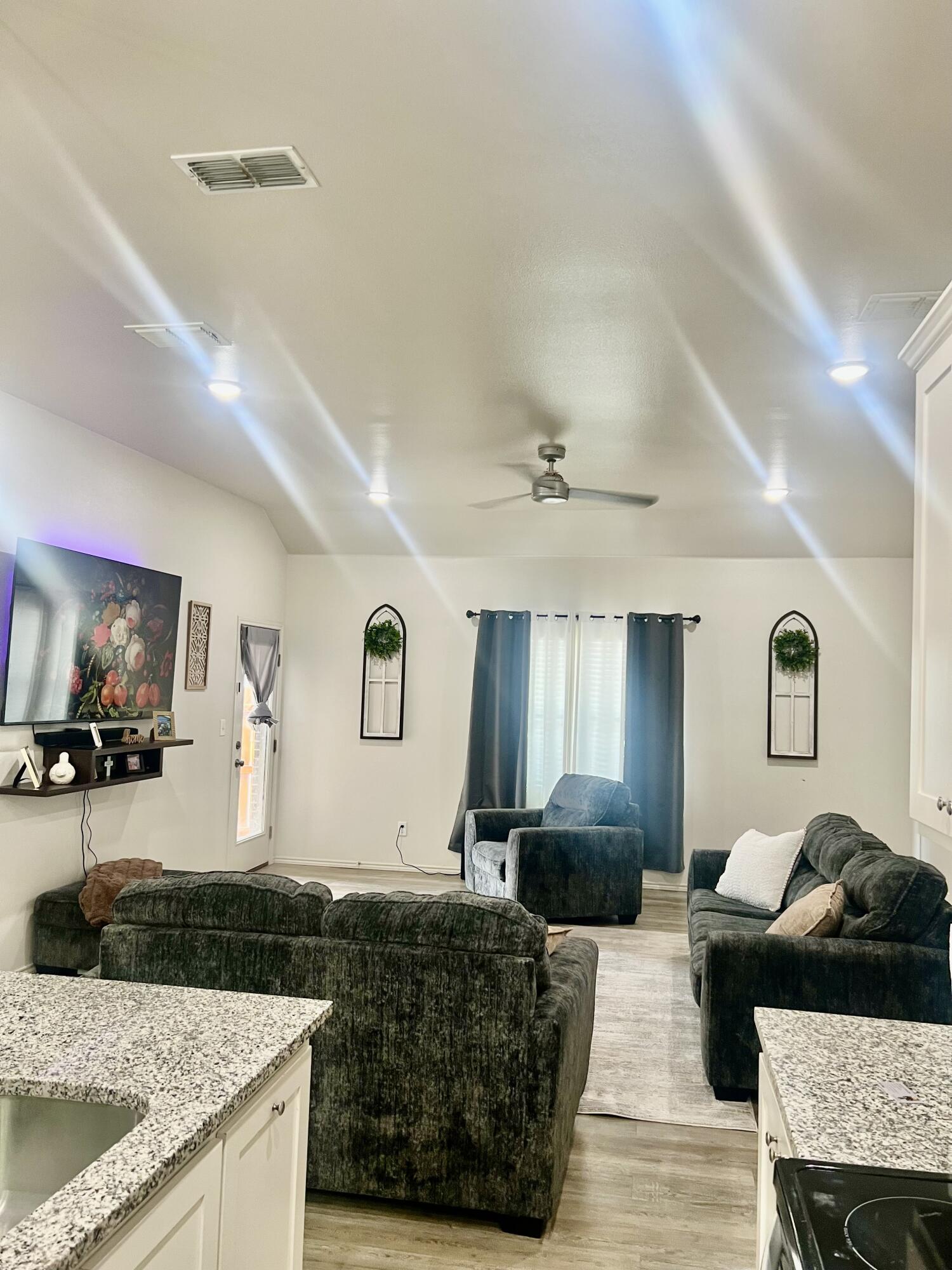 5615 Kemper Street Lubbock, TX 79416 - Photo 2 of 6 a living room with furniture and a flat screen tv