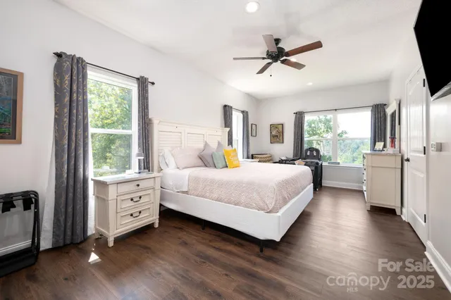 a bedroom with a bed and a large window