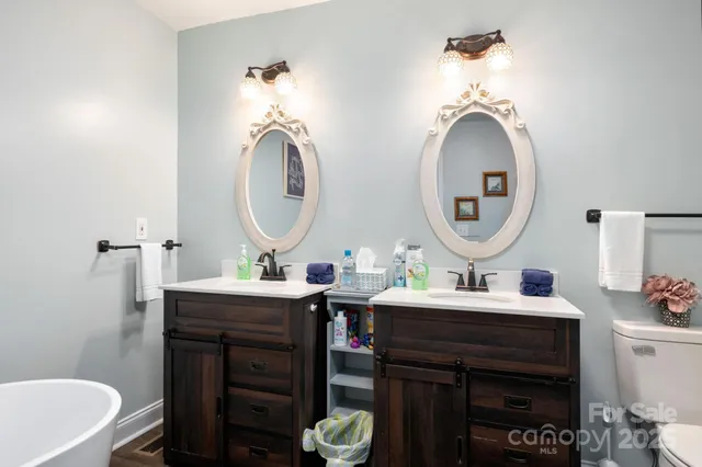 a bathroom with a double vanity sink and a mirror