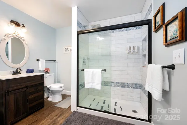 a bathroom with a sink mirror vanity and toilet