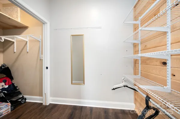 a view of a room with wooden floor and windows
