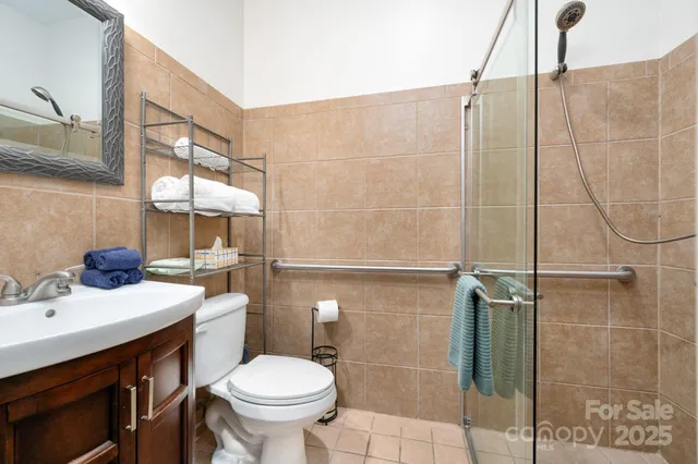 a bathroom with a sink toilet and shower