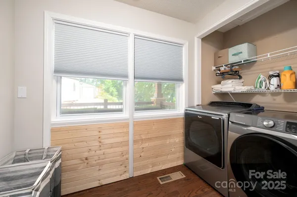 a utility room with cabinets dryer and washer