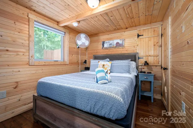 a bed sitting in a bedroom next to a window