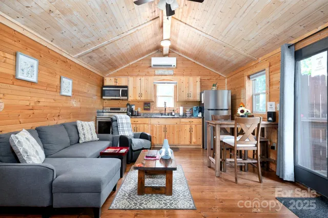 a living room with furniture fireplace and table