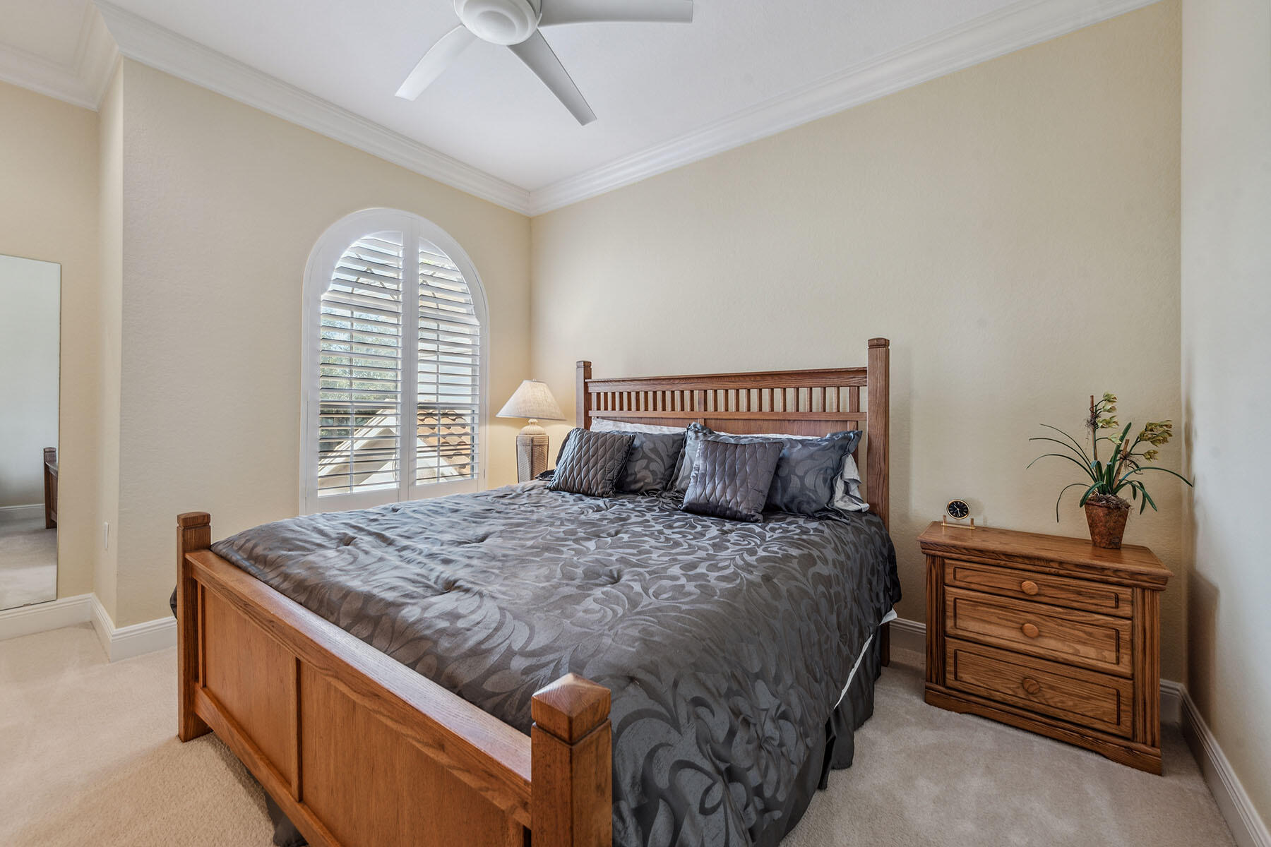 3189 Aviamar Circle, Unit 202 Naples, FL 34114 - Photo 18 of 50 a bed sitting in a bedroom next to a window and a chandelier