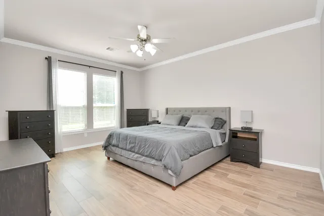 a spacious bedroom with a bed and window