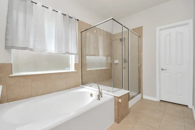 a bathroom with a bathtub and a shower