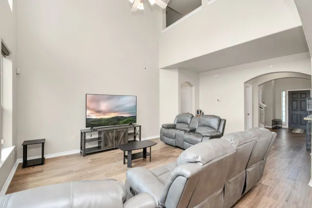 a living room with furniture and a flat screen tv