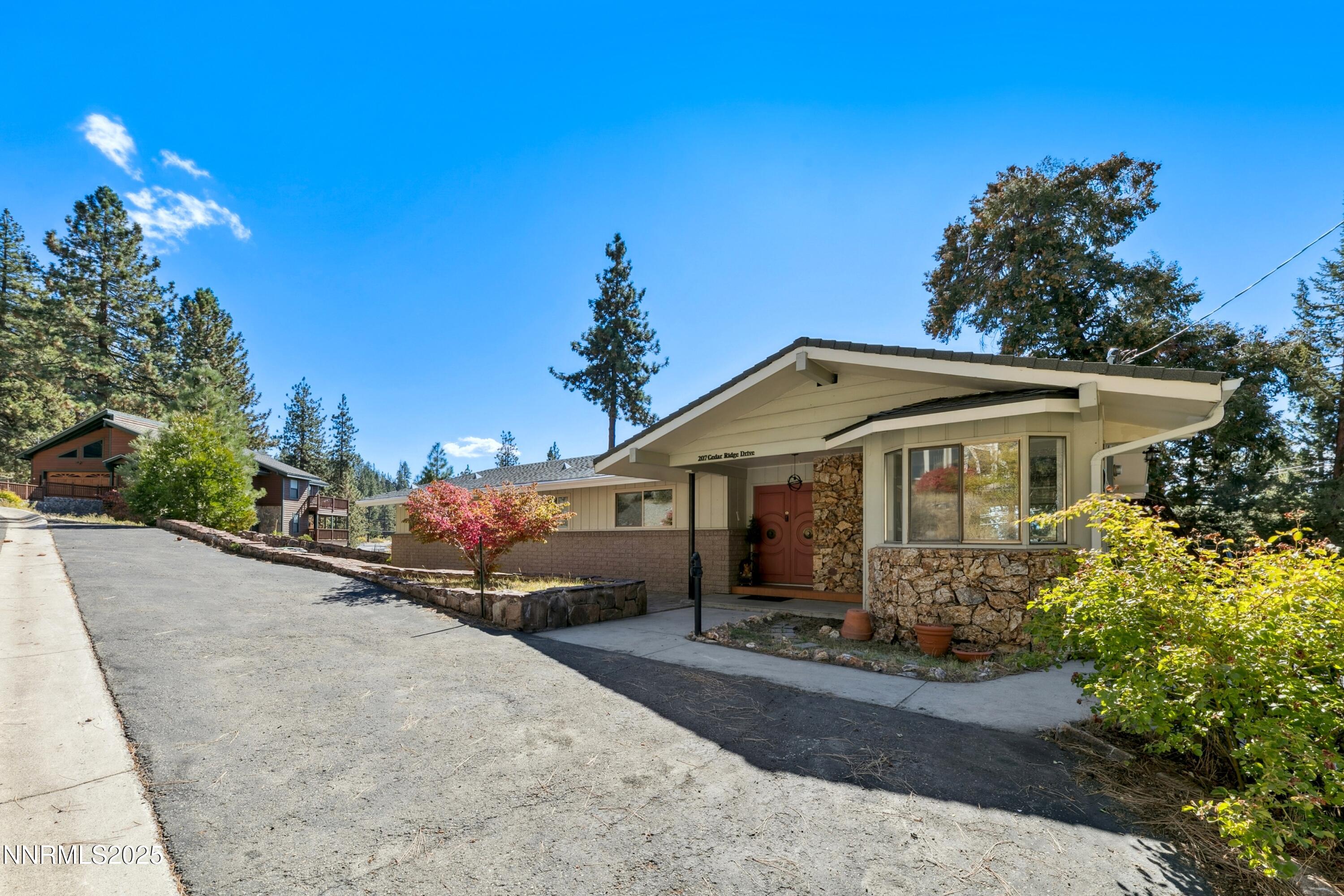 207 Cedar Ridge Drive Zephyr Cove, NV 89448 - Photo 2 of 26 a front view of a house with a yard and potted plants