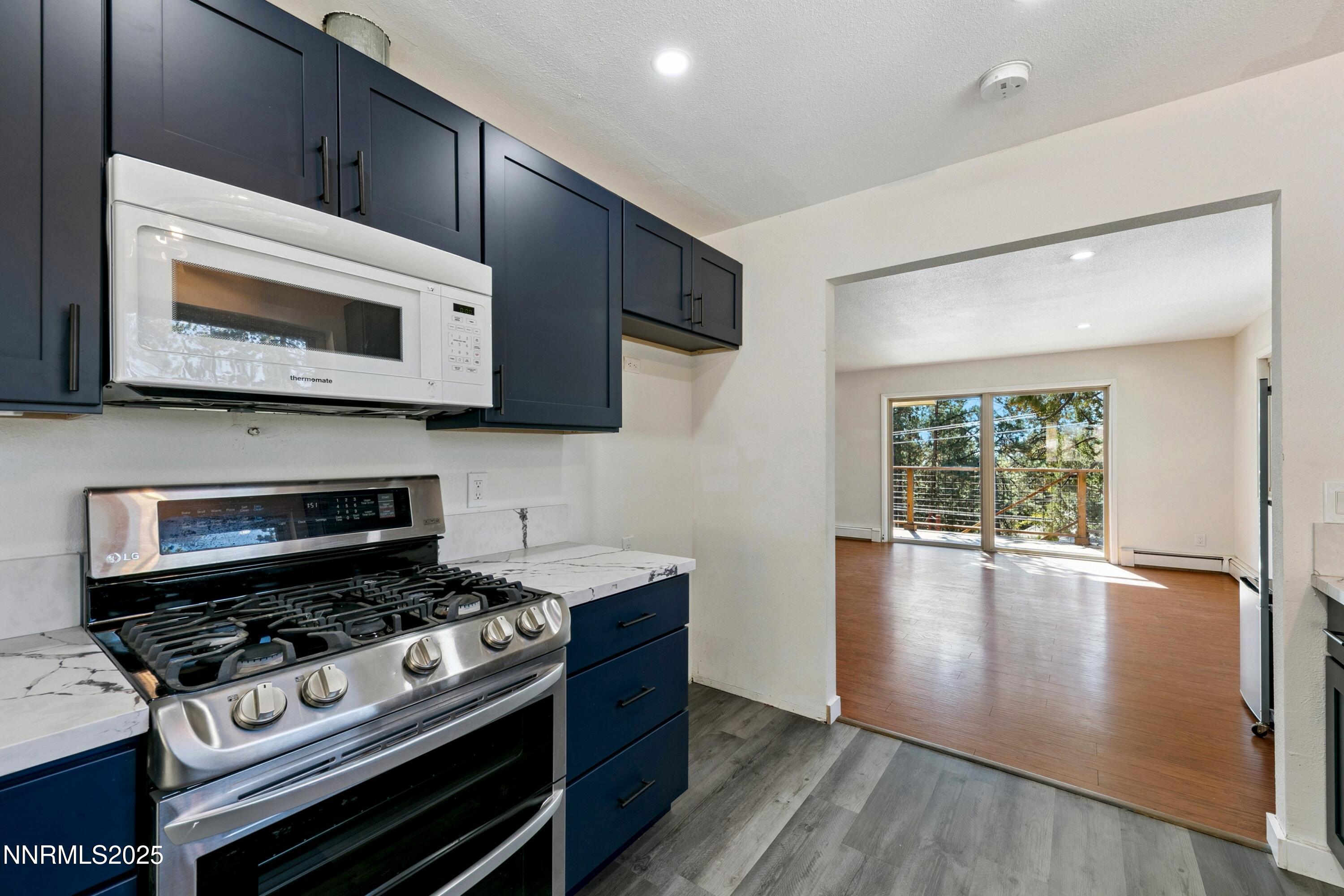 207 Cedar Ridge Drive Zephyr Cove, NV 89448 - Photo 4 of 26 a kitchen with a stove a microwave and window