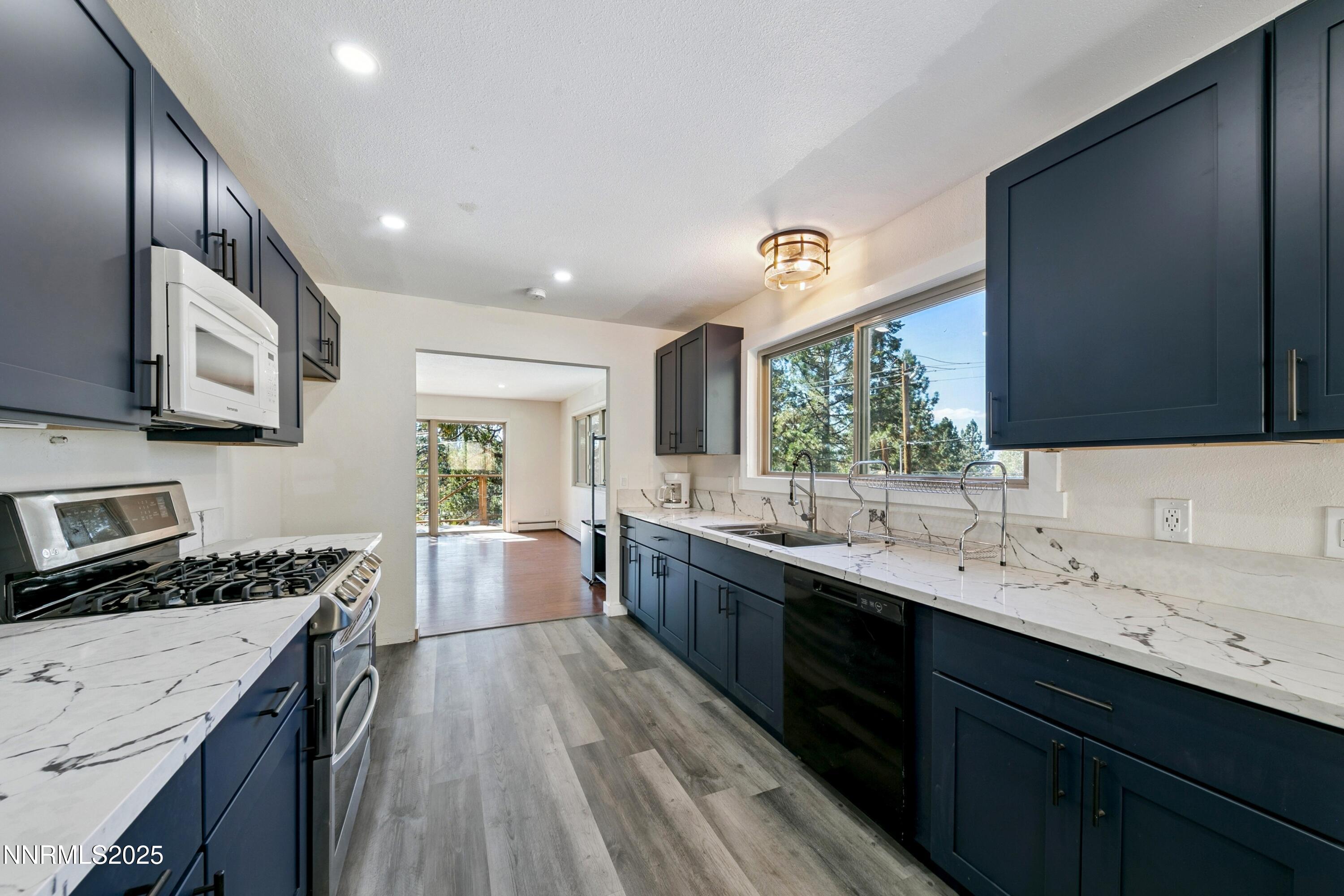 207 Cedar Ridge Drive Zephyr Cove, NV 89448 - Photo 5 of 26 a kitchen with a sink stove and cabinets