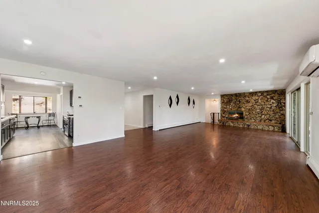 a view of a livingroom with furniture wooden floor and window