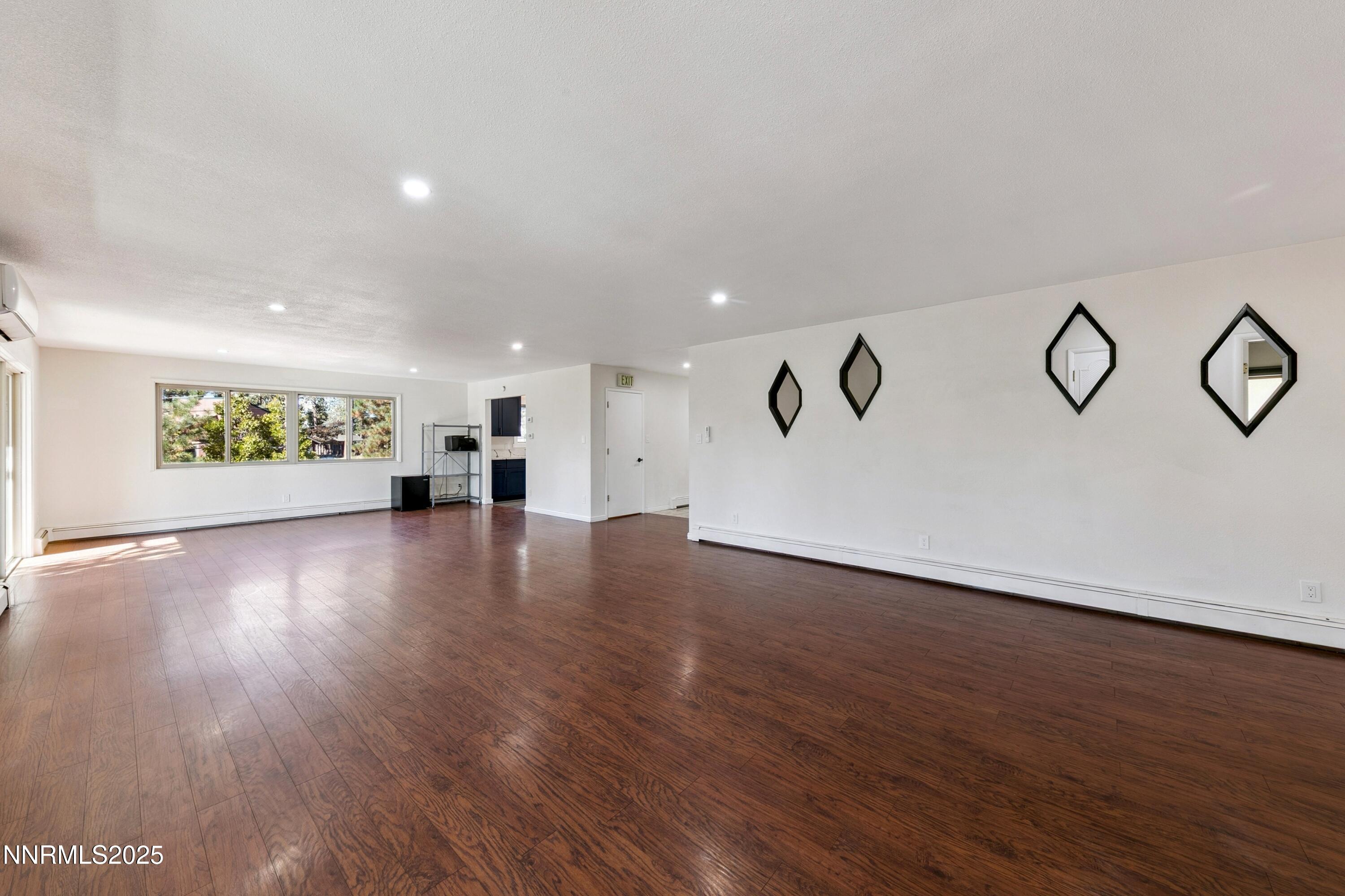 207 Cedar Ridge Drive Zephyr Cove, NV 89448 - Photo 9 of 26 a view of an empty room with wooden floor and a window