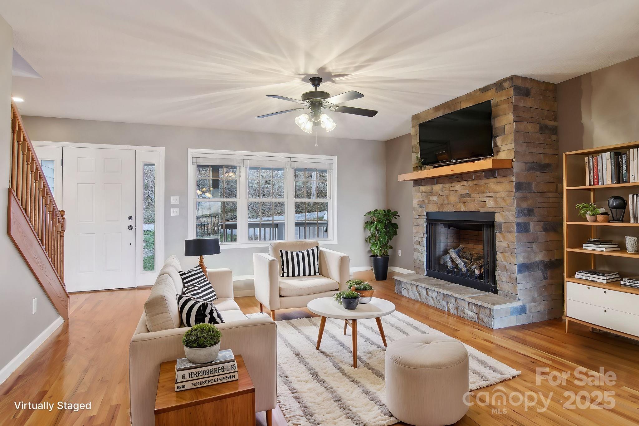 76 Eastern Sky Drive Canton, NC 28716 - Photo 13 of 48 a living room with furniture a fireplace and a flat screen tv