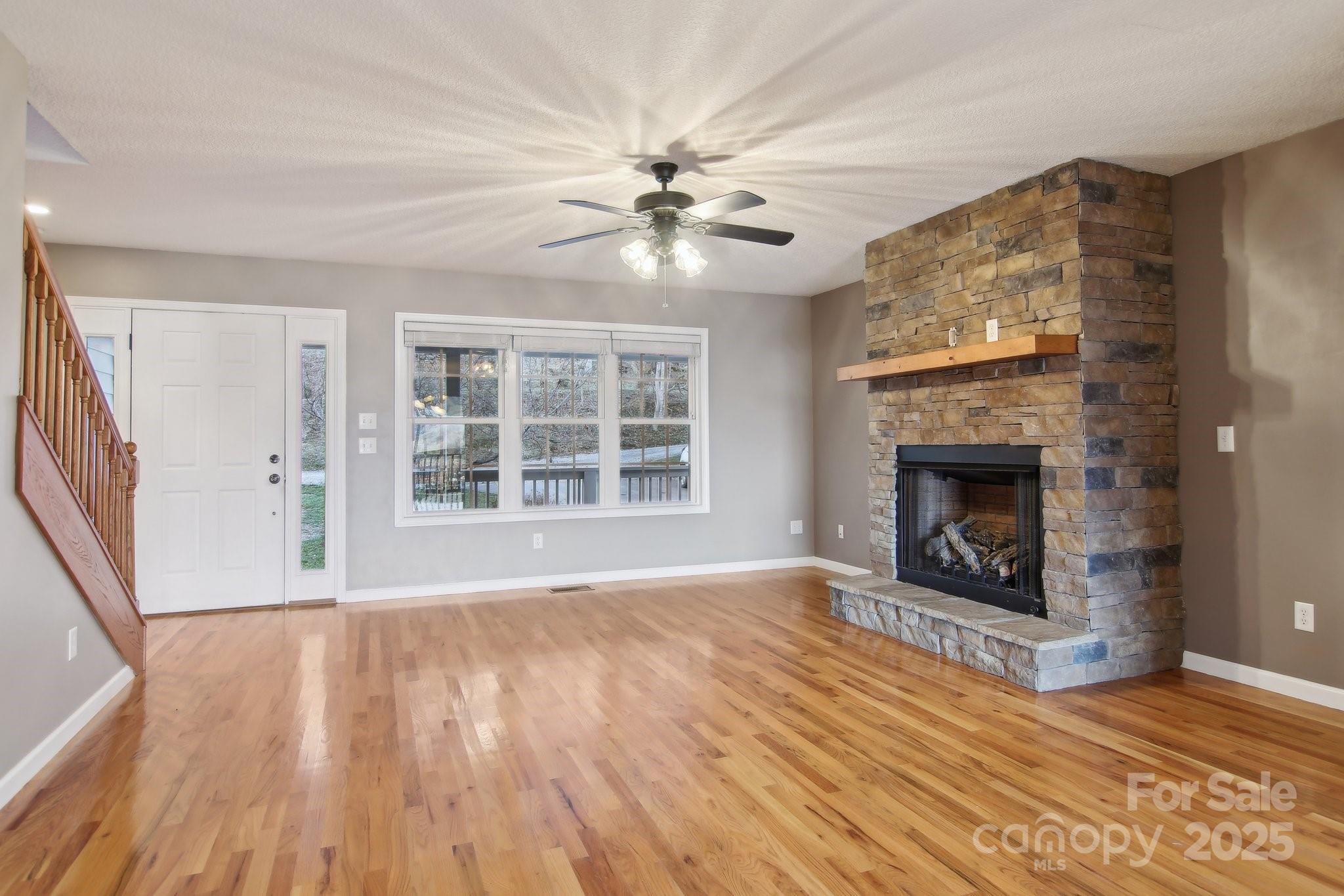 76 Eastern Sky Drive Canton, NC 28716 - Photo 15 of 48 a view of an empty room with wooden floor fireplace and a window
