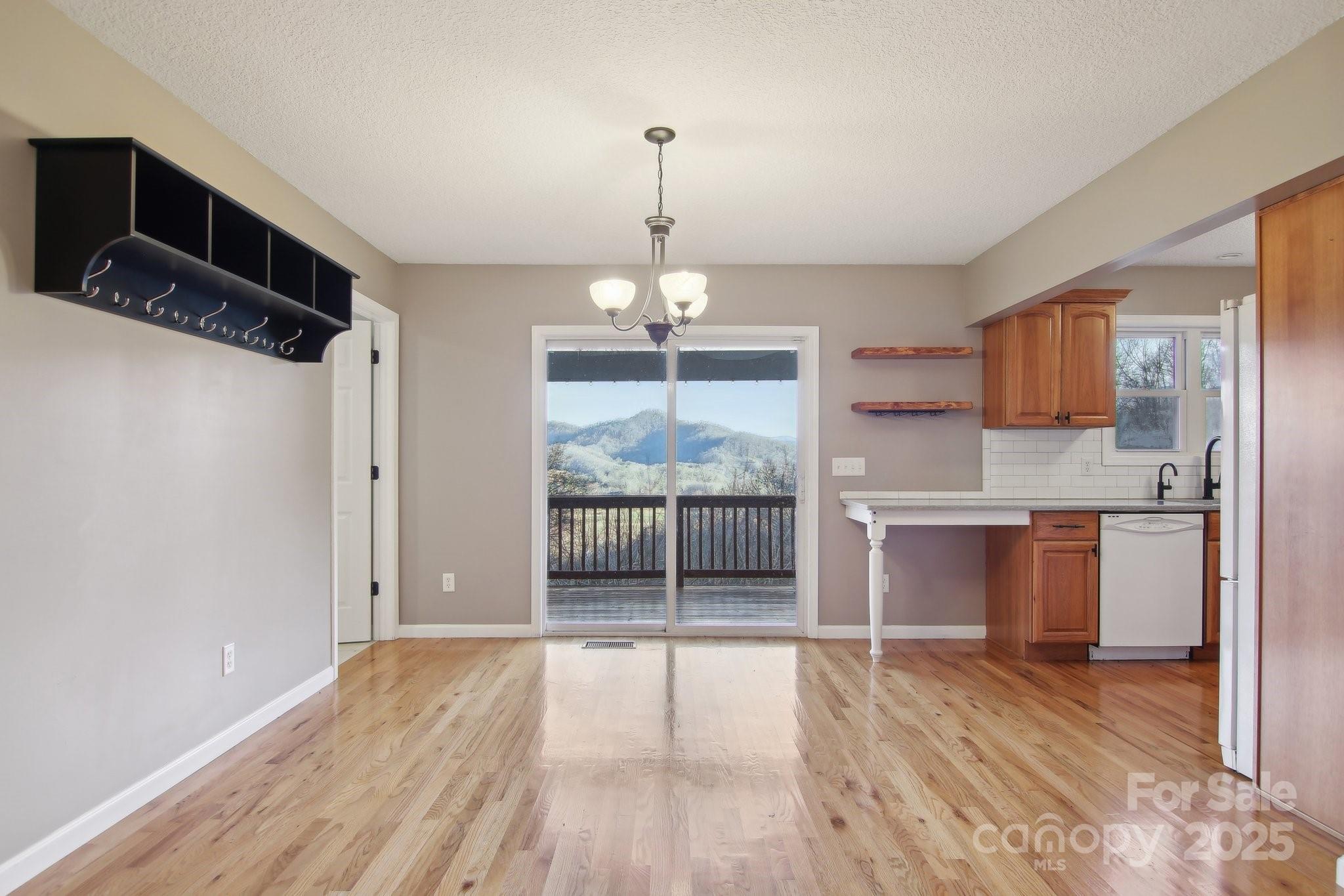 76 Eastern Sky Drive Canton, NC 28716 - Photo 18 of 48 a view of a kitchen with wooden floor and a refrigerator