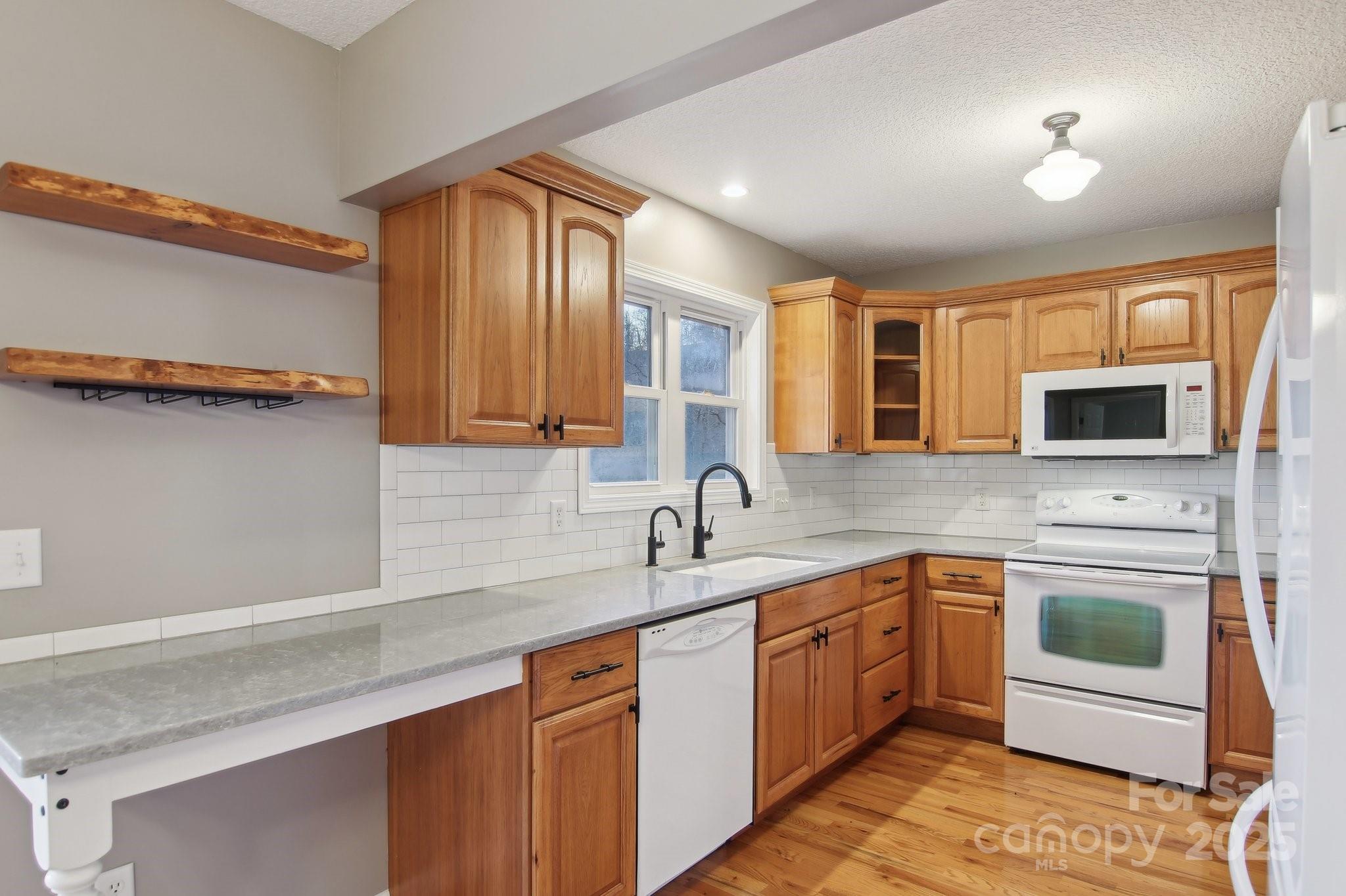 76 Eastern Sky Drive Canton, NC 28716 - Photo 20 of 48 a kitchen with stainless steel appliances granite countertop a sink and a stove